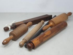 A collection of treen including a single ended Rolling Pin, another Rolling Pin, a treen oat