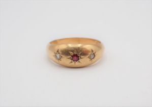 A Ruby and Diamond Ring gypsy-set round ruby between two rose-cut diamonds in 18ct gold, ring size