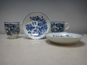 A pair of early Worcester blue and white Cups and Saucers with fence pattern, crescent mark