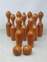 A set of nine vintage pine Carpet Skittles and two Balls