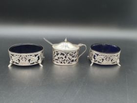 A pair of Continental silver pierced oval Salts with bird and scroll decoration, blue glass