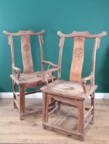 A pair of Chinese yoke-back elm Chairs, the shaped splats with carved roundels and shaped arms,