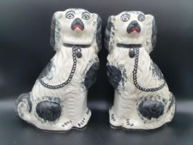 A pair of Staffordshire seated Spaniels with black painted detail, 13in H