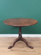 A George II mahogany Supper Table with circular top on turned and fluted column, the tripod base