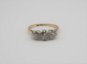 A Diamond three stone Ring claw-set graduated old-cut stones, marked 18ct and PT, ring size K,