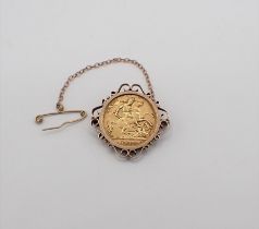 A George V gold half Sovereign 1913 in brooch mount marked 9ct, approx 6.70gms all in