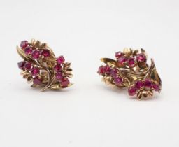 A pair of Ruby Flower Spray Ear Clips each claw-set twelve round stones, marked Garrard, London,