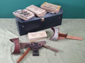 A case containing three hand held stereoscopic viewers and a quantity of stereoscopic slides