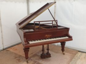 A rosewood Boudoir Grand Piano by Bluther No.72579, raised on reeded turned supports and brass