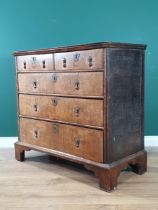 An 18th Century oak and walnut veneered Chest of two short, three long graduated Drawers raised on