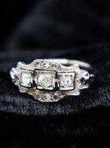 An Art Deco style Diamond Ring pavé-set three graduated principle old and brilliant-cut stones