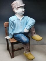 A painted fibreglass Figure of a boy in clogs 2ft 7in H