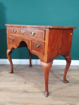 An 18th Century walnut Lowboy with feather banded quarter veneered top, fitted three drawers
