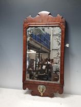 An 18th Century walnut Girandole type Mirror with shaped surmount and with brass fitting, 22in H