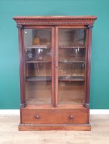 A 19th Century rosewood glazed Display Cabinet with carved and moulded cornice, the doors flanked by