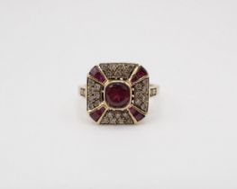 An Art Deco style square Cluster Ring set central round garnet within pavé-set brilliant-cut