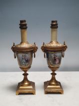 A pair of small Sevres style Table Lamps, painted panels of figures and flowers with gilt metal