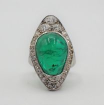A mid 20th Century Emerald and Diamond Cocktail Ring set irregular shaped emerald cabochon within