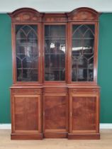 An Edwardian mahogany inverted breakfront Bookcase with double domed top above an inlaid frieze of