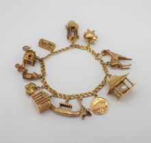 A fancy link 18ct gold Bracelet suspending approx twelve charms, some 9ct some 18ct gold, approx