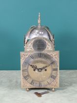 An antique Lantern Clock with bell surmount, arched brass dial, silvered chapter ring, pierced and