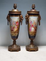 A pair of Sevres style Table Lamps with panels painted lovers in landscapes, the reverse painted