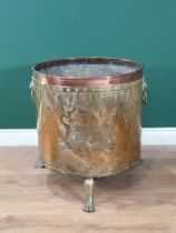 A Victorian brass and copper Log Cauldron with lion mask ring handles, with embossed coats of arms