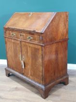 An 18th Century figured walnut veneered Bureau with sloped fall front enclosing four drawers, a