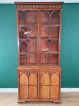 A Gothic oak Bookcase with moulded cornice above a pair of astragal glazed doors enclosing