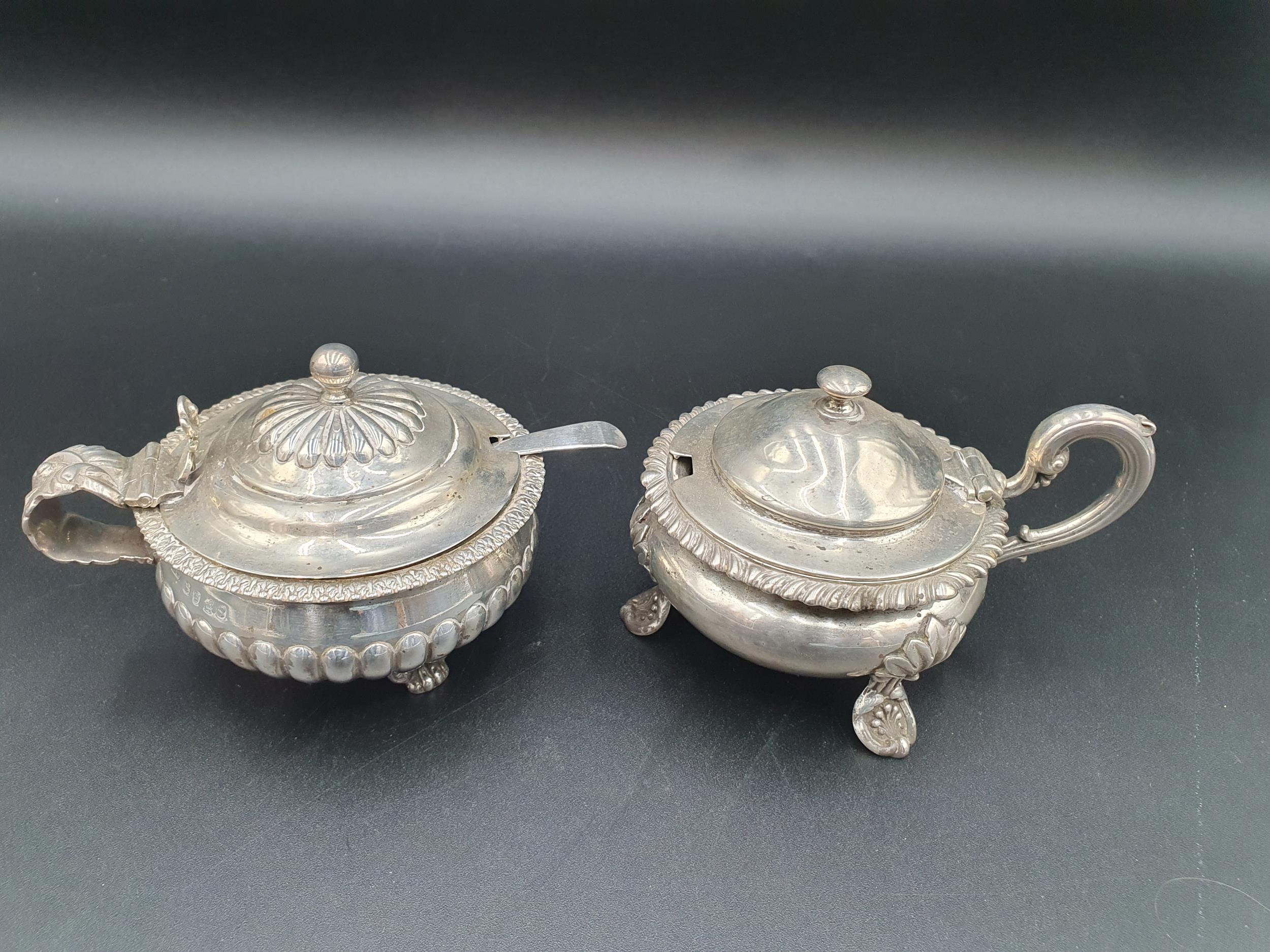 A George III silver large circular Mustard Pot, semi-fluted on anthemion and paw feet, London