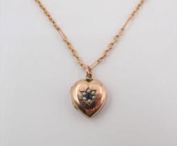 A heart shaped Locket the front set round blue stone within seed pearls on chain marked 9ct,