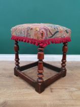 An 18th Century walnut Stool with crewel work seat on turned supports and squared stretchers, 19in H