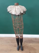 An antique child size Dressmaker's Mannequin with open wicker body and wooden lower legs and