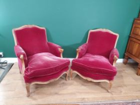 A pair of French beechwood Armchairs with shaped and carved cresting rails, serpentine seat rails on