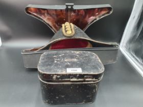 A pair of Naval Epaulets, Belt and Bicorn Hat, in two japanned metal cases. The hat box with brass