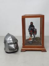 A miniature Figure of a Knight and a miniature Pigface Basconet Helmet