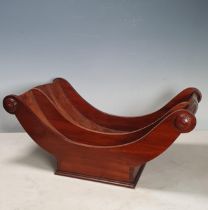 An early 19th Century mahogany Cheese Coaster with roundels to the ends of the half-turned
