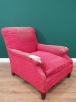 A Howard and Sons deep seated Armchair in red upholstery, on tapered front supports, the rear