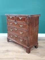 An 18th Century walnut Bachelor's Chest, the feather banded top folding over to reveal a baize