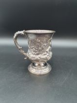 A George IV silver Mug finely embossed cherubs, fruiting vines, flowers and scrolls on pedestal