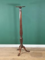 A mahogany Torchere Stand with dished top on octagonal baluster tapering column and carved tripod