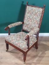 A 19th Century bobbin turned Armchair with upholstered back and seat and raised bobbin turned