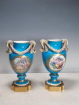A pair of Sevres style Vases with scroll handles, oval panels painted sprays of flowers on