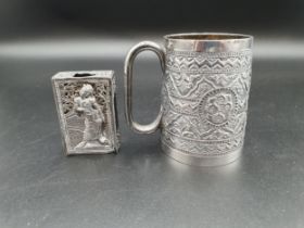 A Victorian silver Mug with all over floral embossing, Birmingham 1889, and a white metal Matchbox