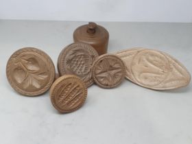 Six carved and turned wooden Butter Prints, two with strawberry designs, another with barley