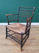 A 19th Century Sussex Type painted faux bamboo Elbow Chair with rush seat.