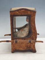 A Doll's Sedan Chair with shaped top, bevelled glass panels, the outside covered in floral