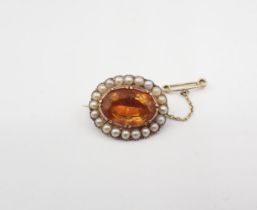 A Citrine and Pearl Brooch set oval-cut citrine within a frame of pearls, 25mm x 20mm, approx 7.