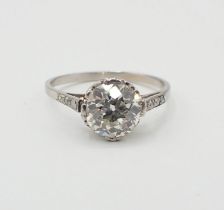 A Diamond single stone Ring claw-set old-cut stone, estimated 1.60cts, between trios of eight-cut