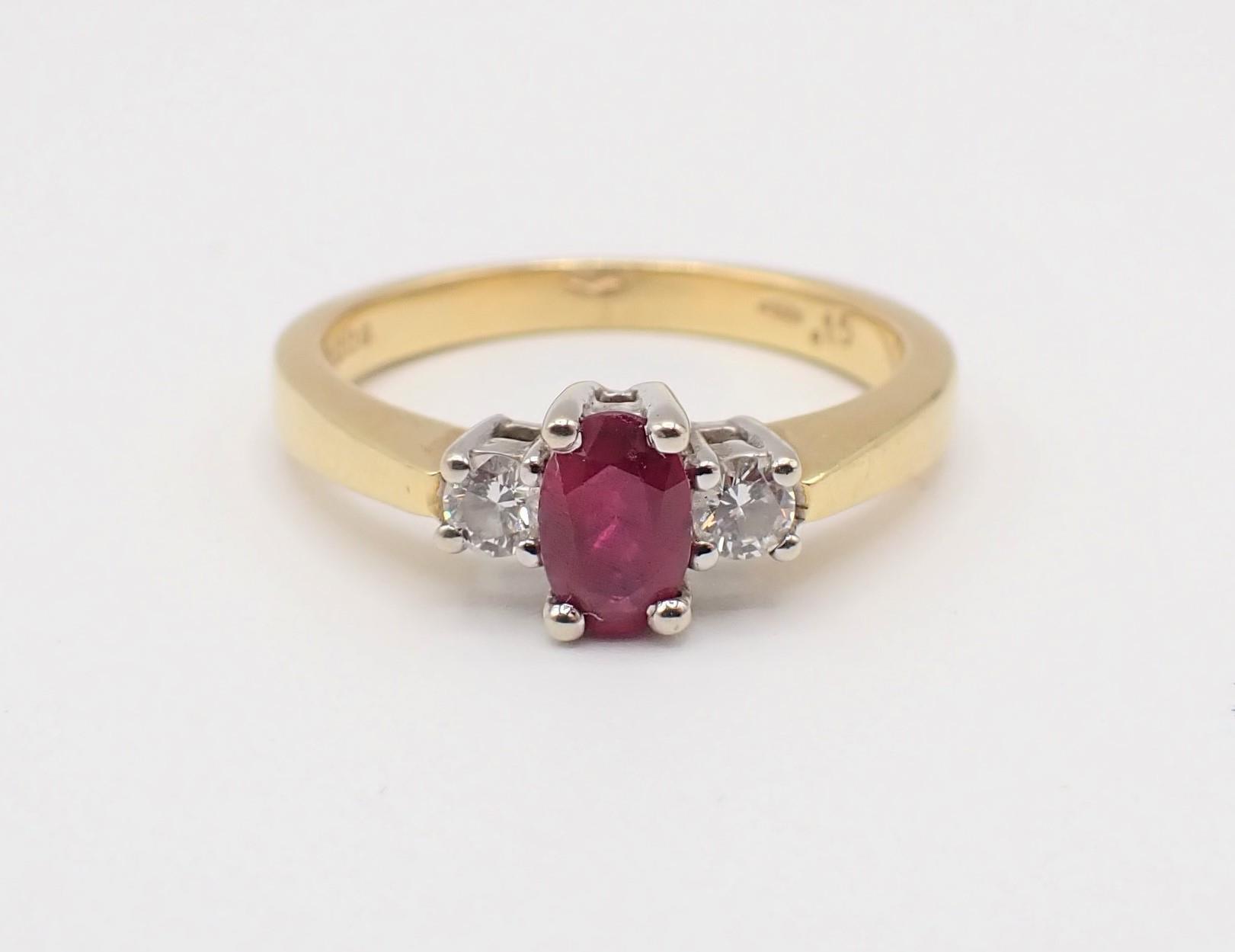 A Ruby and Diamond three stone Ring claw-set oval-cut ruby between two brilliant-cut diamonds, total
